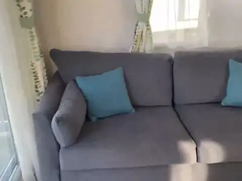 Grey sofa with teal cushions in the lounge