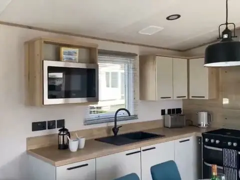 Kitchen with a microwave, sink and a full-size range-style oven