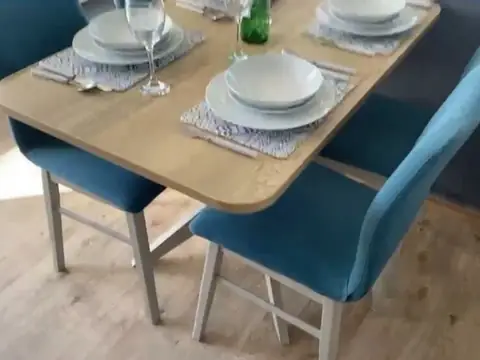 Dining table laid with plates and glasses