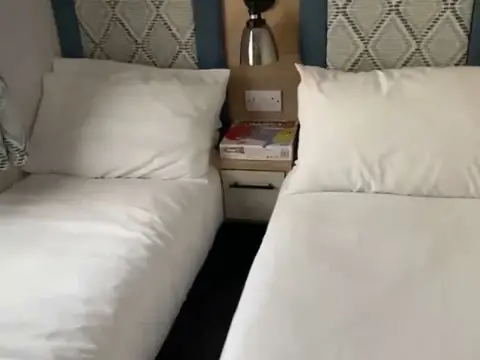 Twin bedroom with two single beds and a bedside table