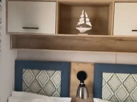 Bedroom headboards with reading lights and a sailing-boat shelf